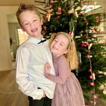 Magnus and Tilde in front of Christmas tree